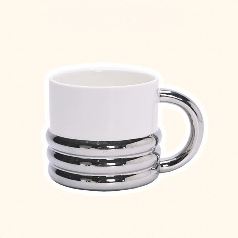 Front view of the chunky ribbed ceramic mug in a white and chrome finish - RoomDen.