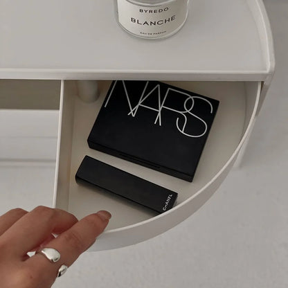 Hand opening a drawer of the makeup organizer, revealing NARS and Chanel cosmetics. - RoomDen