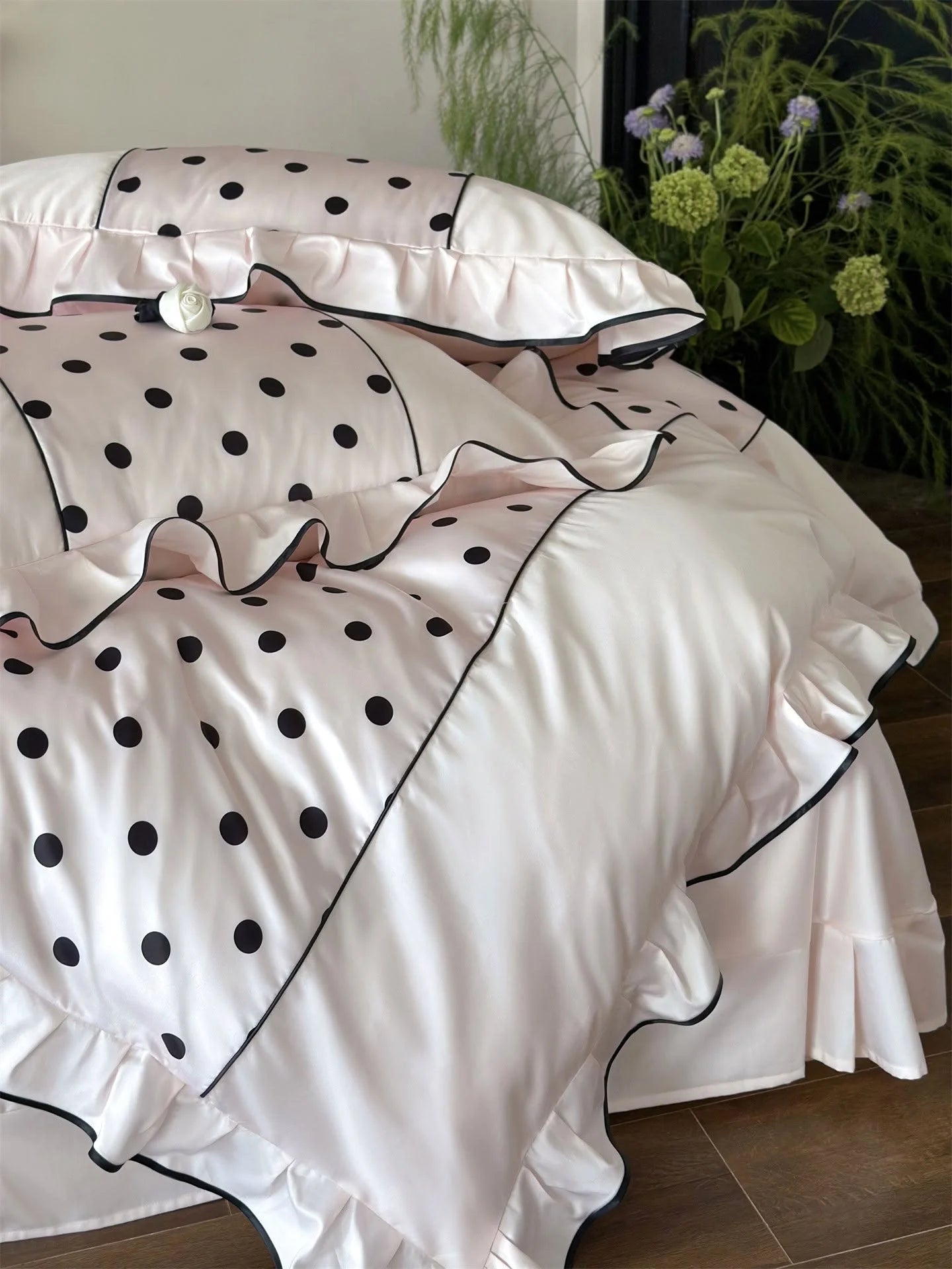 Detail shot showing the texture and ruffled edge of the Blush Pink & Black Polka Dot duvet cover - RoomDen.