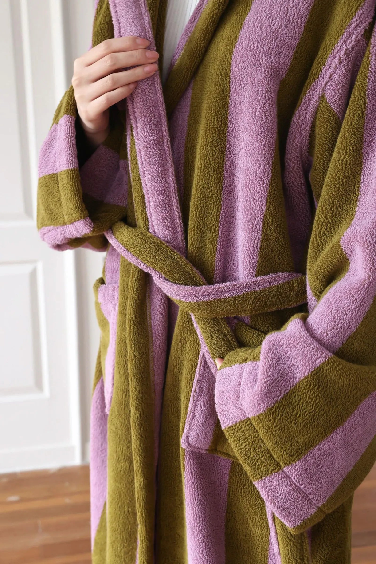 Close up of the waist tie belt and soft fabric texture of the striped robe.
