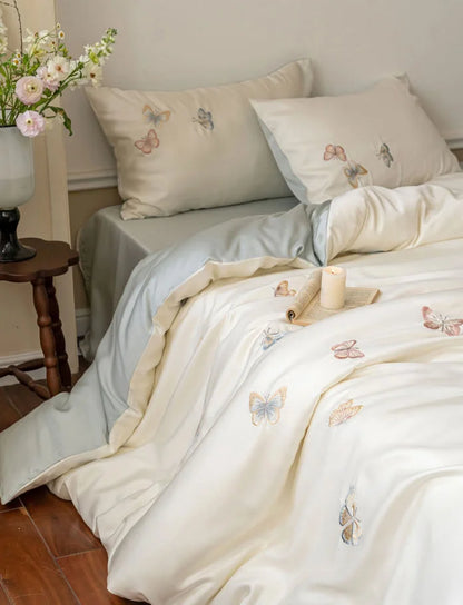Three-quarter view of the bed, showing the soft folds and sheen of the Tencel bedding.