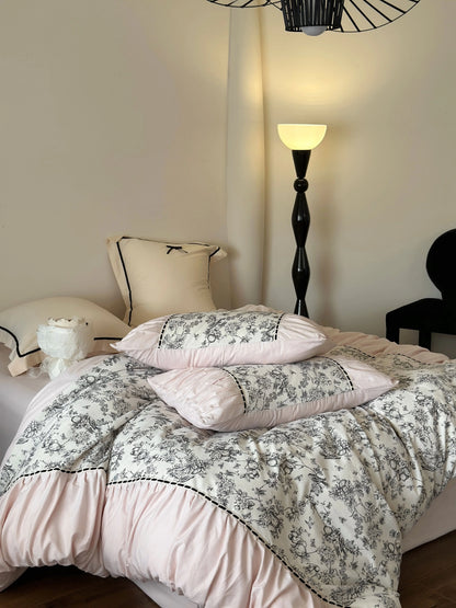 Full view of the Pink Toile bedding set on a bed, highlighting the pink and black color combination. - RoomDen