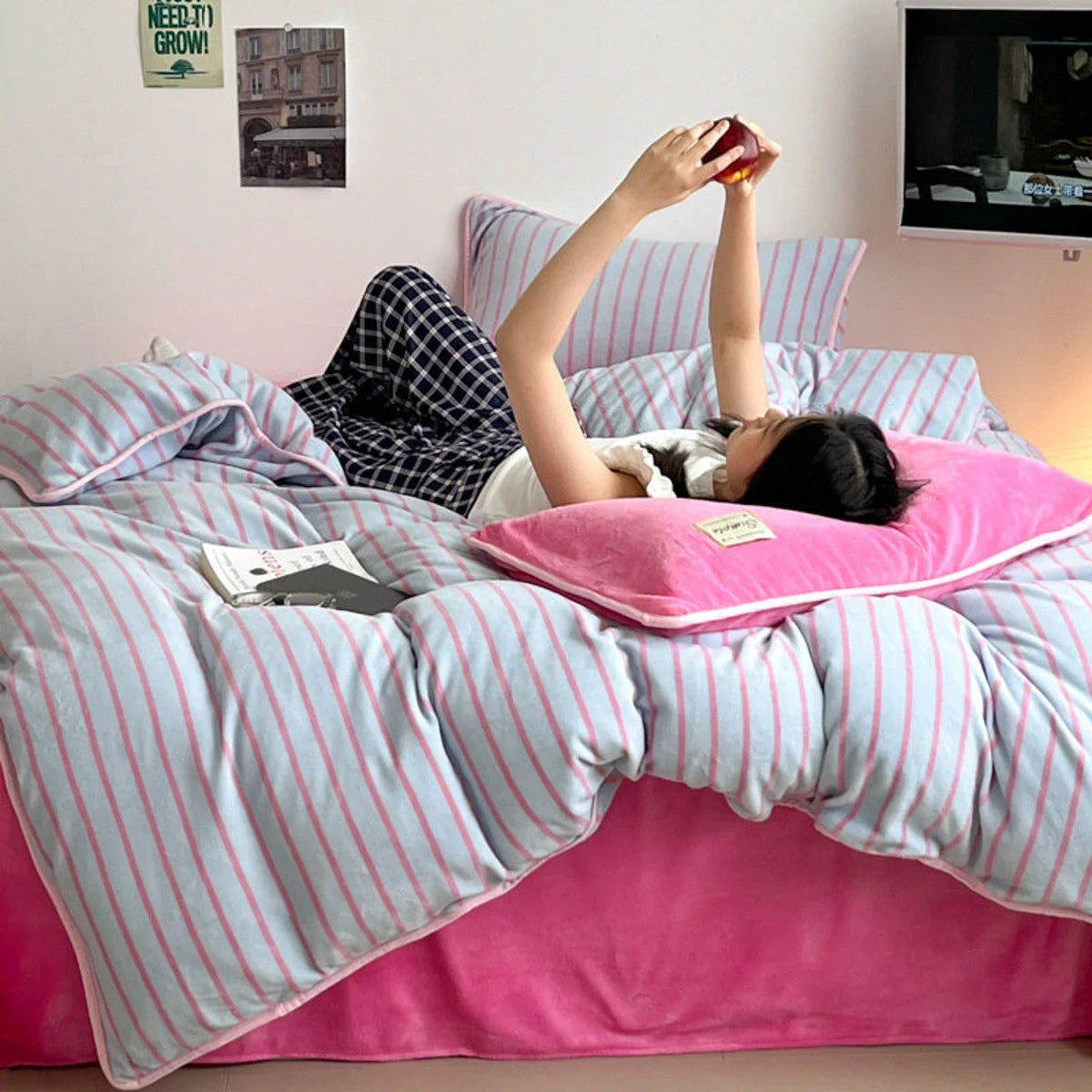 A person lying down and relaxing in the cozy Bubblegum Pink striped flannel fleece bedding. - RoomDen
