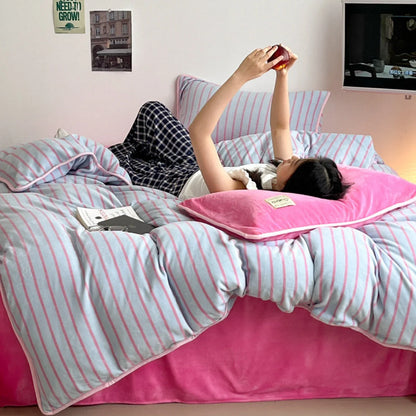 A person lying down and relaxing in the cozy Bubblegum Pink striped flannel fleece bedding. - RoomDen