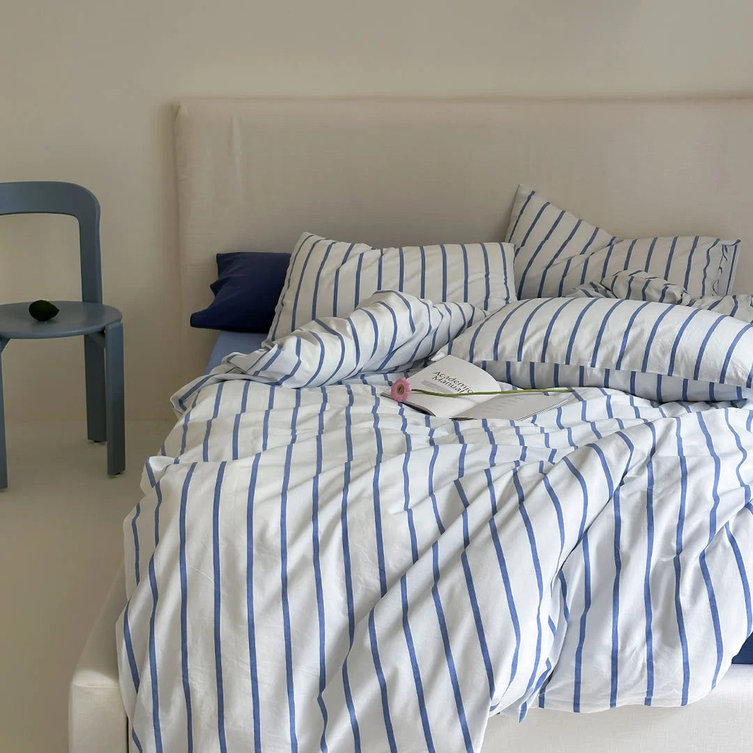 Blue Striped Pillowcase and Duvet Cover on Bed with Blue Chair - RoomDen