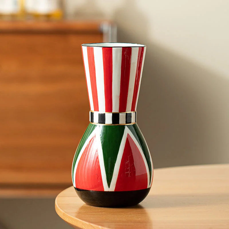 Front view of the red-striped harlequin ceramic vase on a light wood table, highlighting its glossy finish. - RoomDen