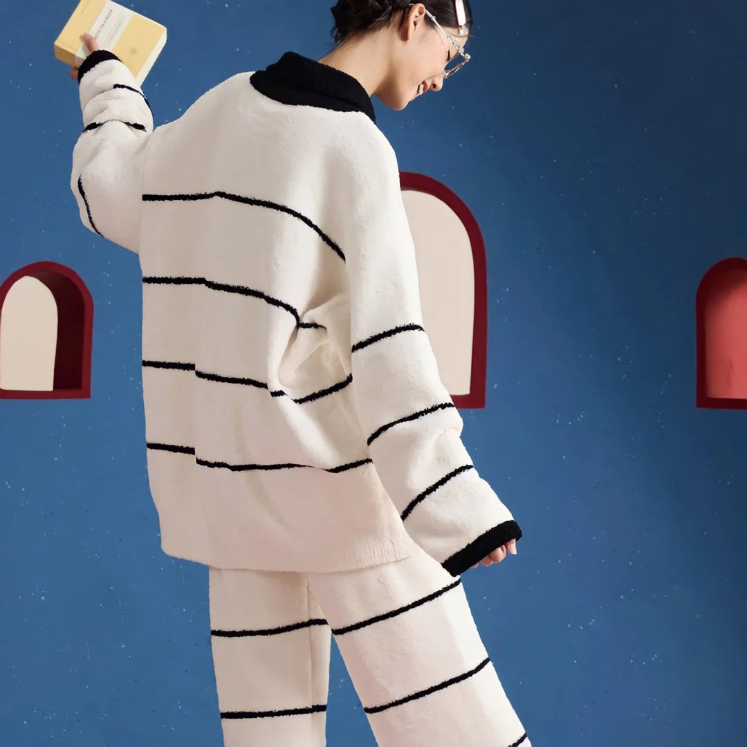 Back view of the model wearing the striped fleece pajama top and pants, showcasing the pattern continuity - RoomDen.