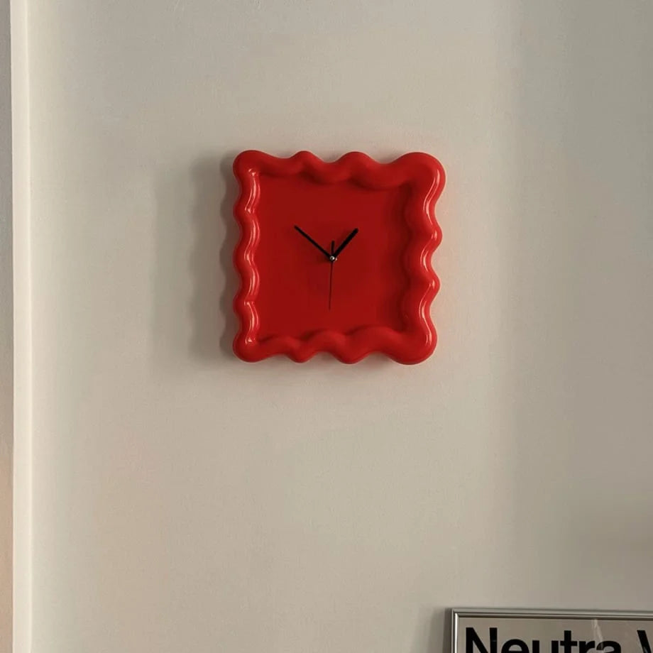 Front view of the red Wavy Squiggle Clock, highlighting its bold color and minimalist black hands. - RoomDen