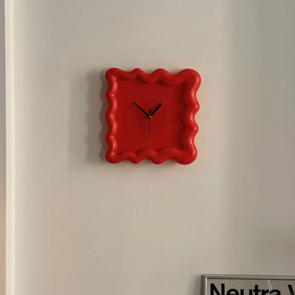 Front view of the red Wavy Squiggle Clock, highlighting its bold color and minimalist black hands. - RoomDen