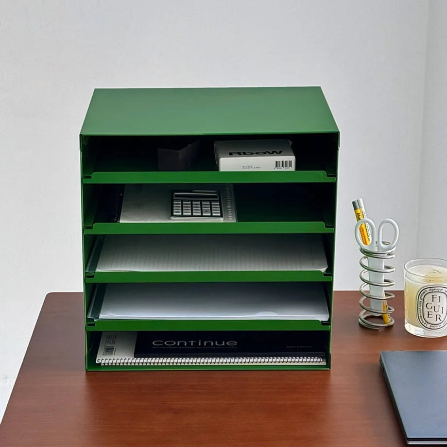 Close-up of the five tiers of the Kelly Green metal organizer filled with office supplies - RoomDen.
