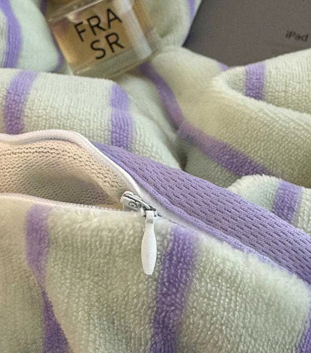 Close-up of the plush texture and zipper detail on the Lavender Striped flannel fleece bedding. - RoomDen