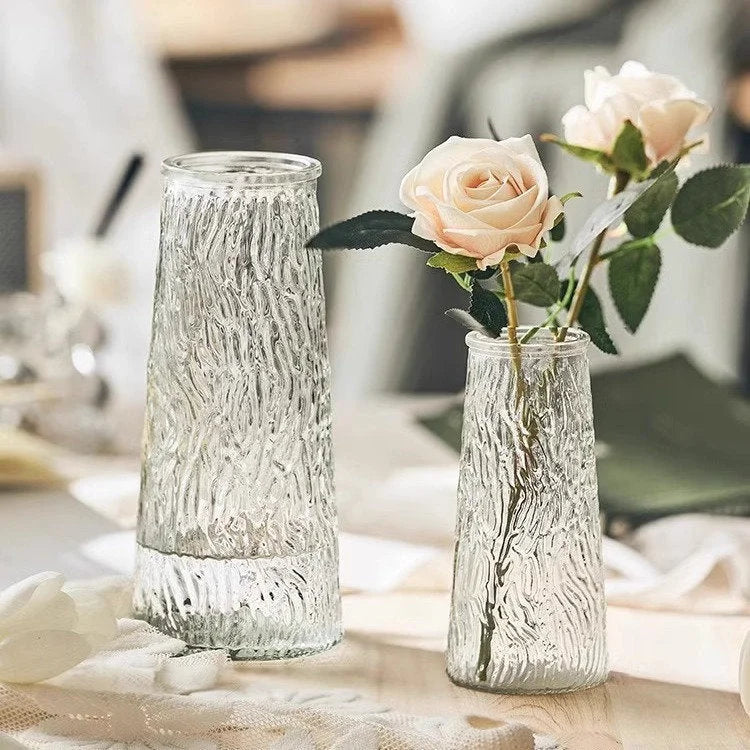 Small Ribbed Glass Vase with pink roses placed next to a Large Bark Textured Glass Vase. - RoomDen