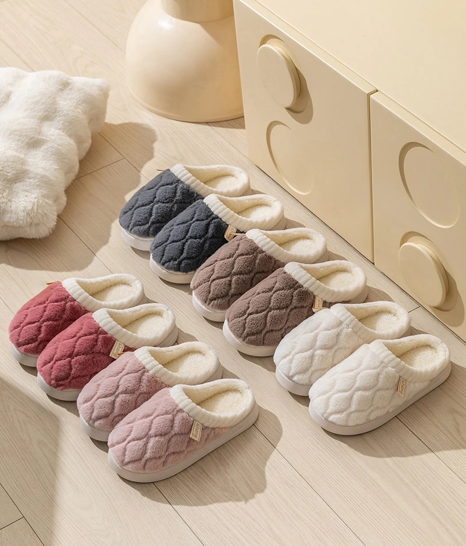 Full collection of RoomDen quilted slippers in Pink White Grey and Brown lined up - RoomDen
