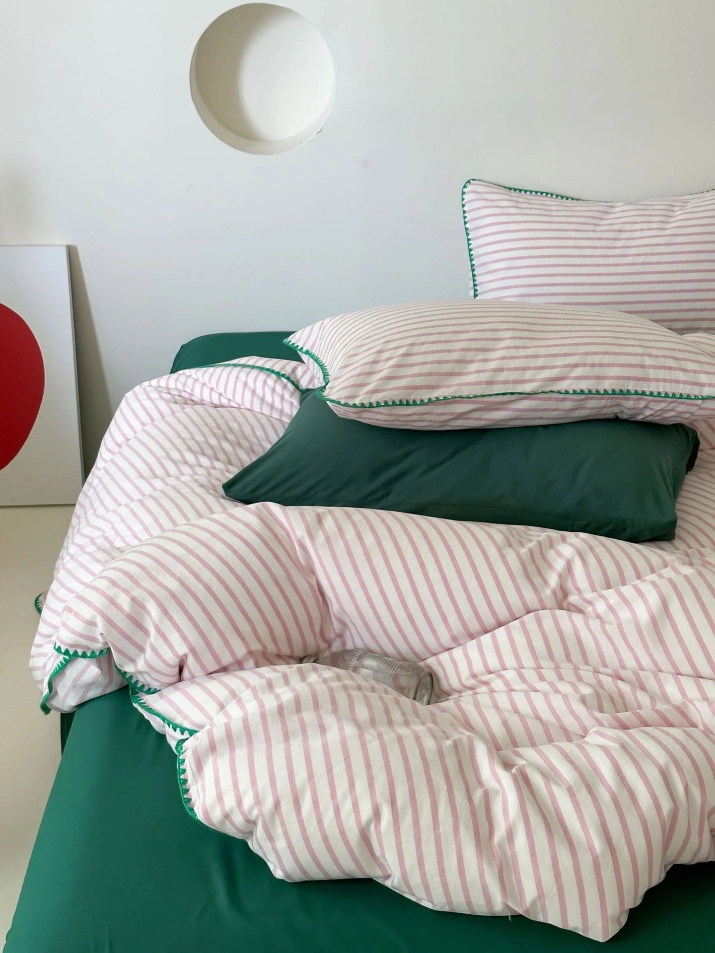 Detail of Pink Striped Pillowcase and Green Sheet - RoomDen