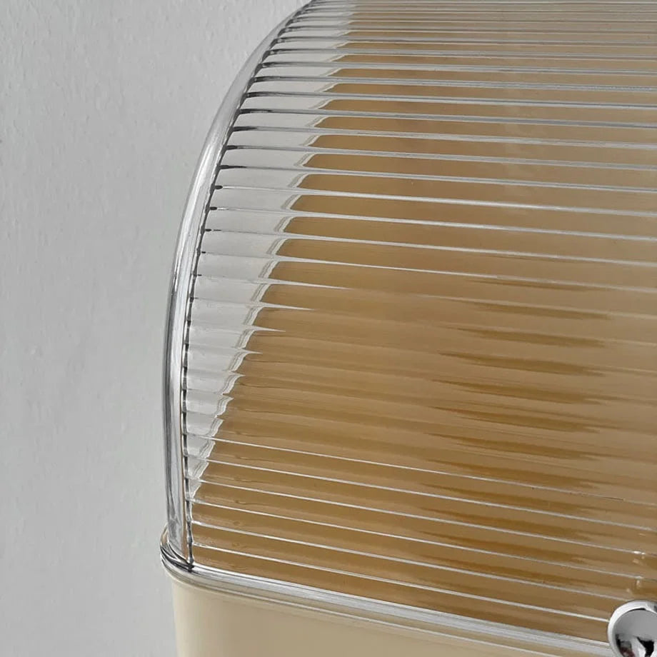 Detail shot focusing on the texture of the transparent ribbed plastic lid of the cosmetic box.
