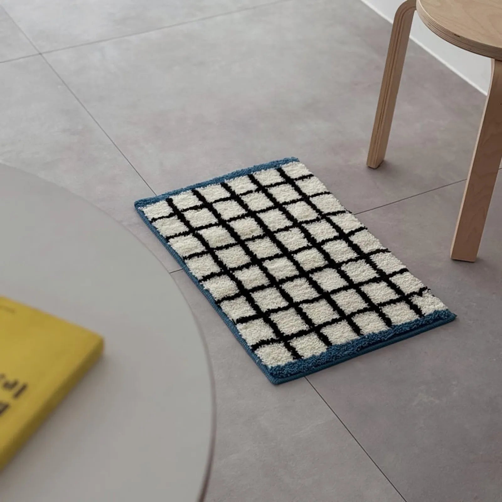 Isolated view of the White & Blue Checkered Tufted Accent Rug on a neutral floor - RoomDen