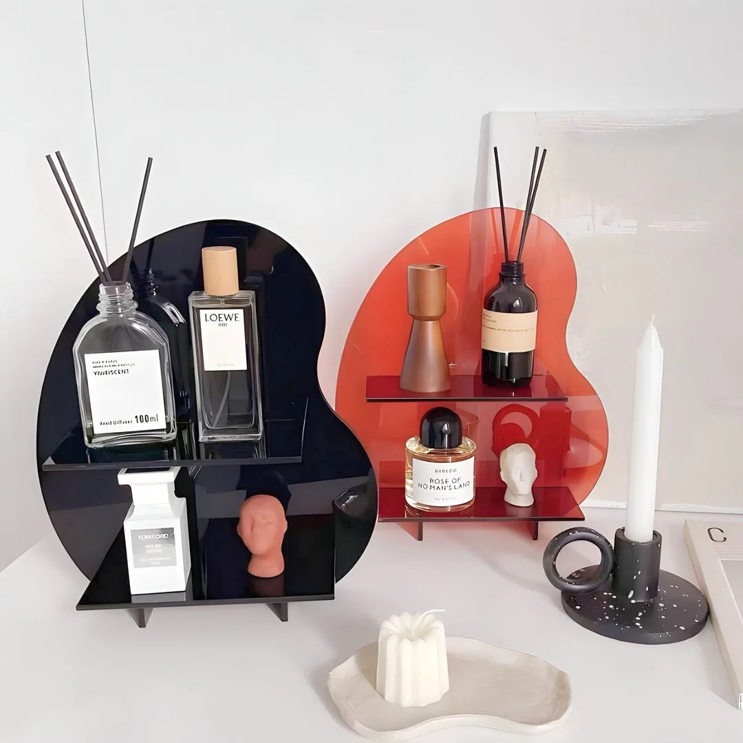 Side-by-side view of the black and red wavy acrylic display shelves with various decor items. - RoomDen