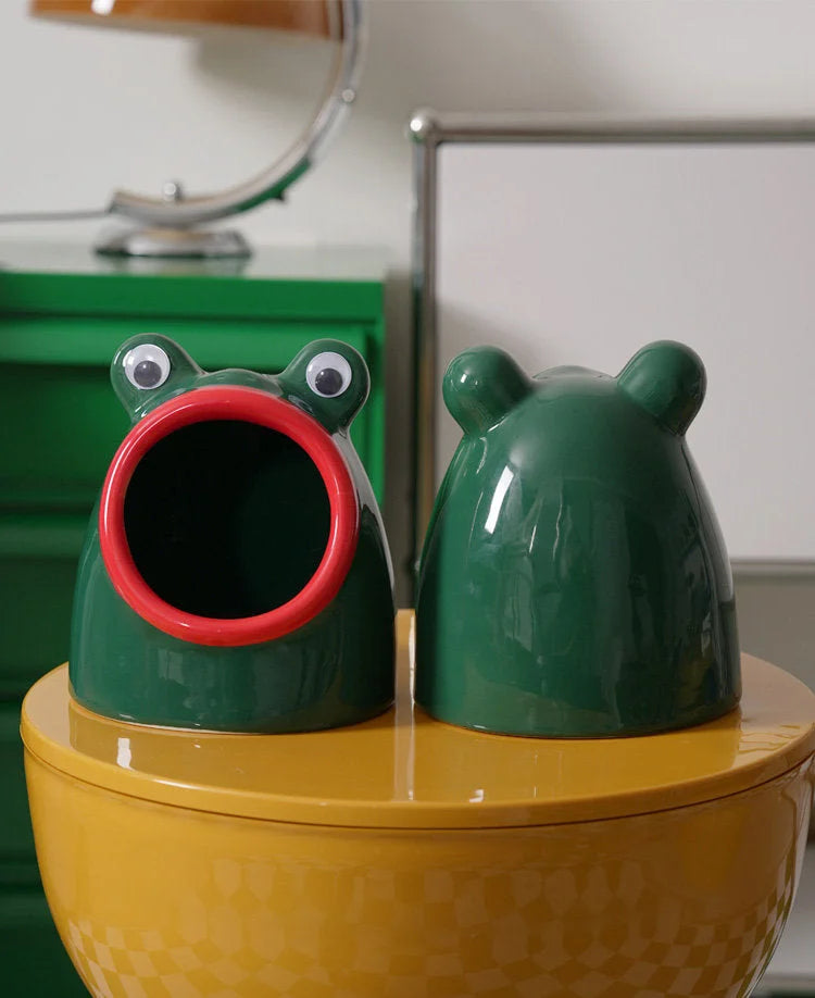 Front and back view of the green Googly Eye Frog ceramic catchall tray on a yellow surface. - RoomDen