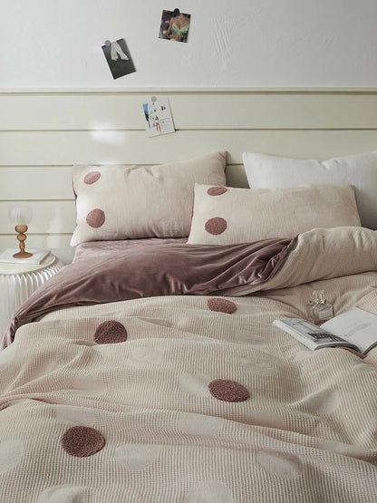 The Dusty Rose Polka Dot Flannel Fleece Bedding Set on a bed, showing the soft pink and mauve tones. - RoomDen