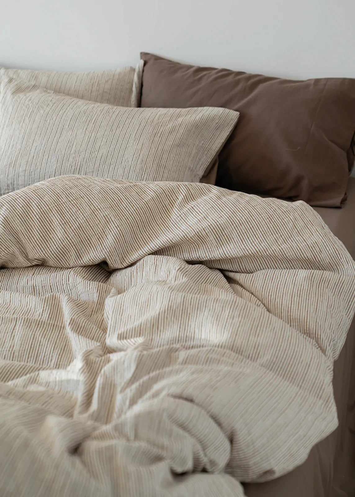 Detailed shot of the soft, wrinkled texture of the Latte Brown Washed Cotton Bedding Set - RoomDen