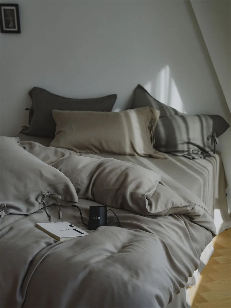 Full view of the Misty Grey Tencel Bedding Set in a minimalist bedroom with warm sunlight - RoomDen