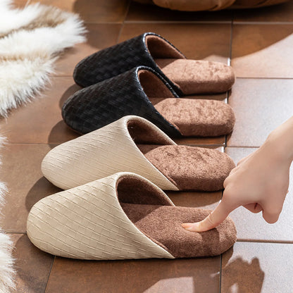 Close-up of hand touching the soft plush lining of a black woven slipper