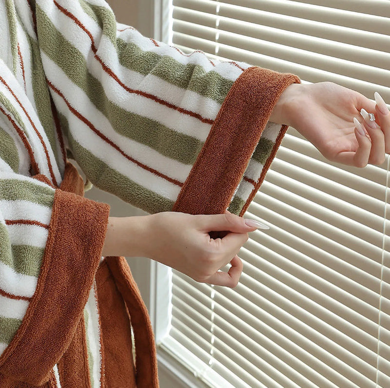 Close-up of the rust-colored cuff detail and green striped texture of the cottagecore robe. — RoomDen