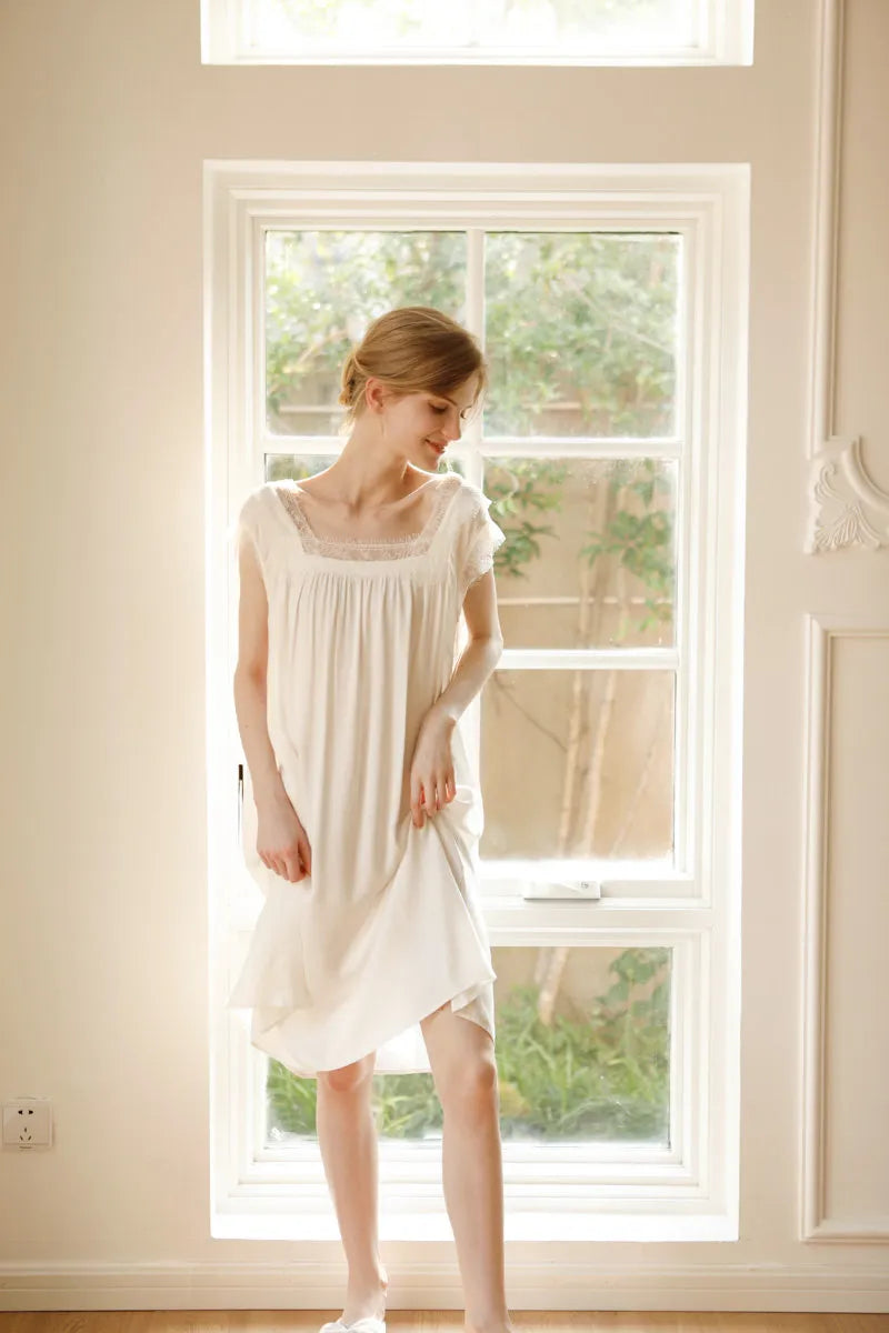 Full body shot of model in white cotton sateen pajama dress indoors - RoomDen