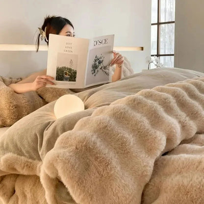 A person reading in bed, wrapped in the Warm Beige Plush Ruched Flannel Fleece Bedding Set. - RoomDen