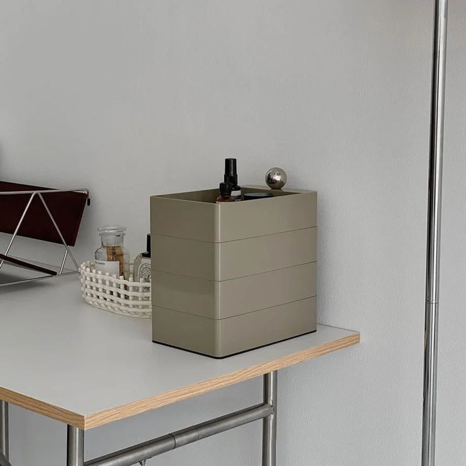 The Khaki Grey makeup organizer shown closed from a side angle on a desk.