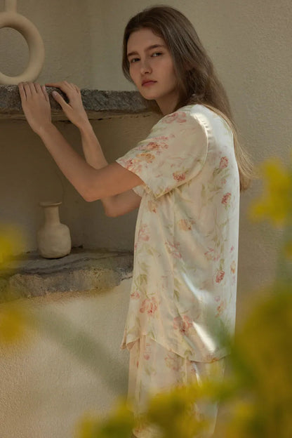 RoomDen Cream Floral Summer Pajamas - Side profile leaning against stone shelf