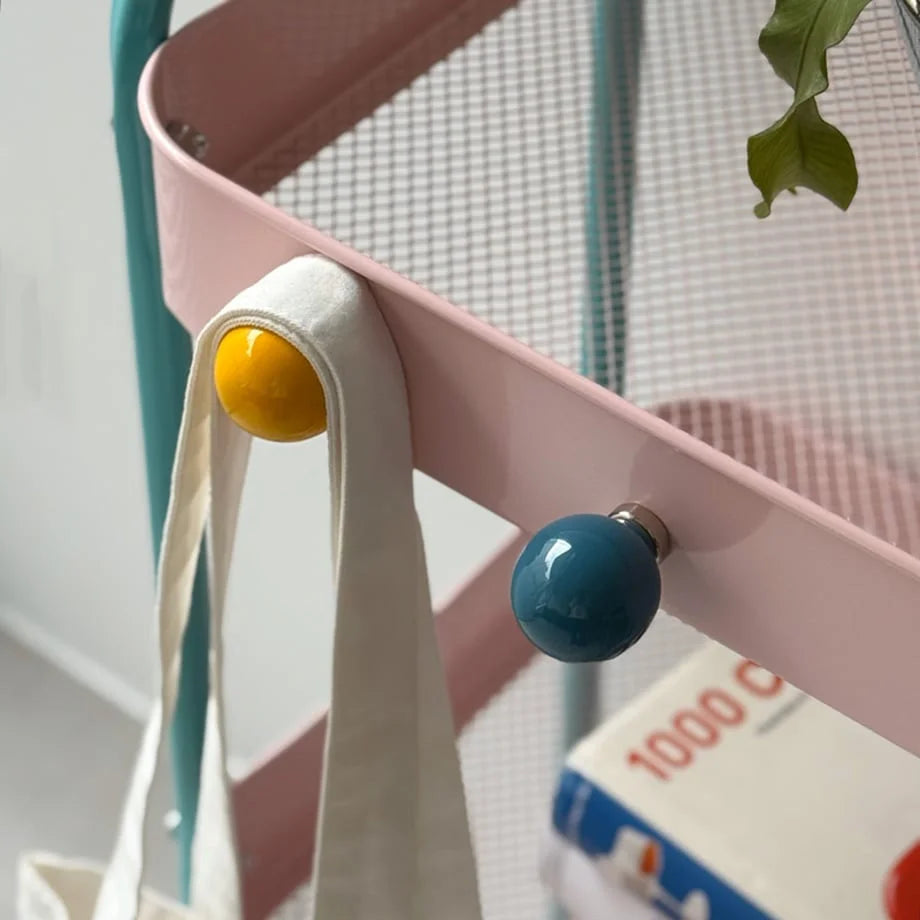 Detail shot showing the powerful magnet on the yellow ball-shaped hook attached to a cart. - RoomDen