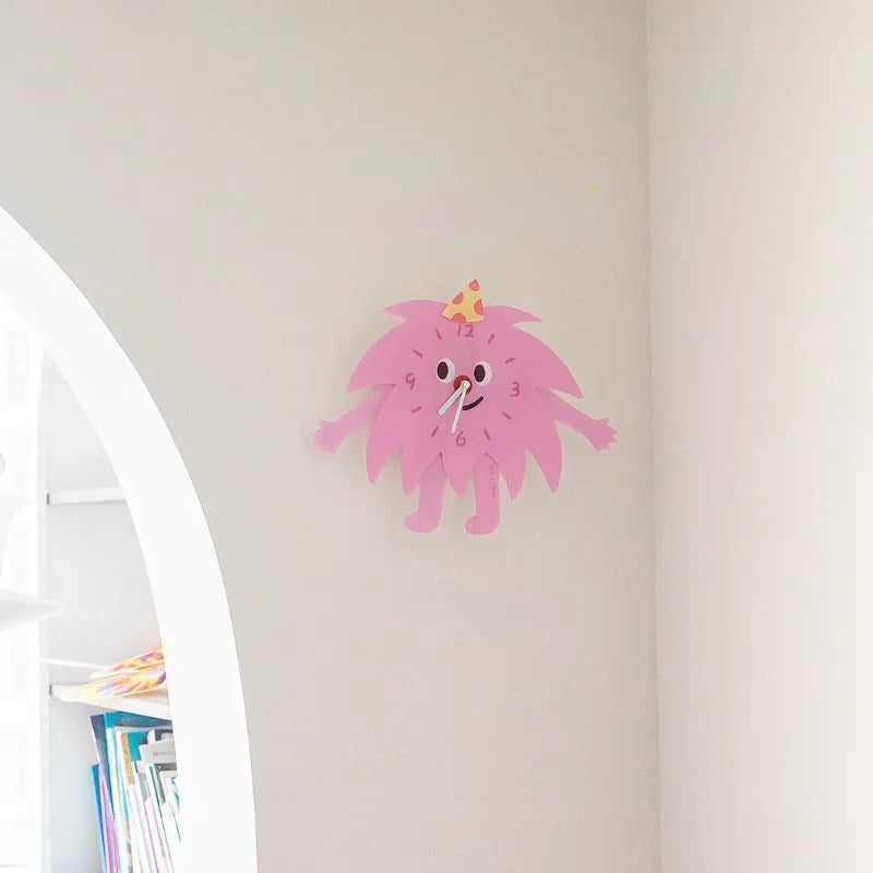 The Party Monster Acrylic Clock hanging on a clean white wall, showcasing its wall decor versatility - RoomDen.