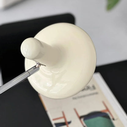 Top-down view of the glossy cream shade of the minimalist desk lamp - RoomDen.