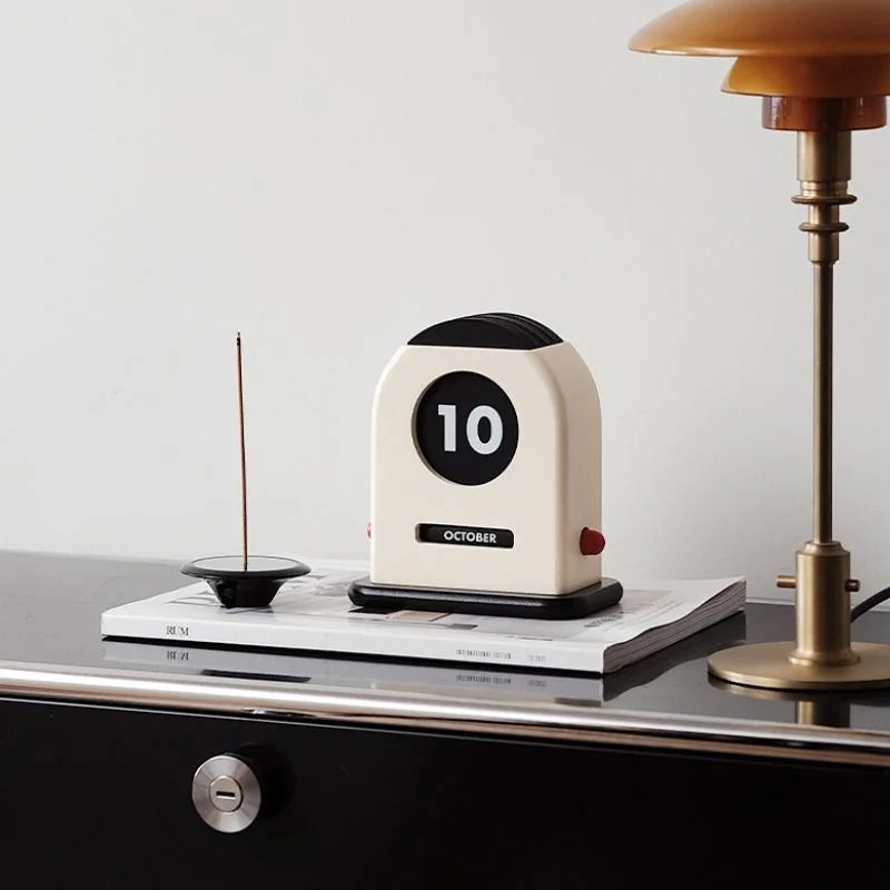 Retro Wooden Perpetual Desk Calendar on a black drawer next to a vintage brass lamp - RoomDen