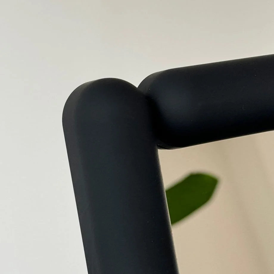 Detail shot of the corner joint on the black melamine mirror frame. - RoomDen