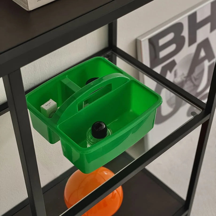 Close-up of the green ABS organizer caddy holding a perfume bottle and a small box. - RoomDen