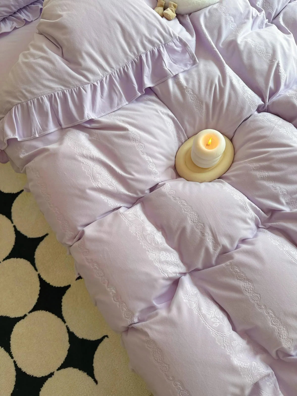 Close-up on the plush texture and embossed jacquard floral pattern of the lavender duvet cover. - RoomDen