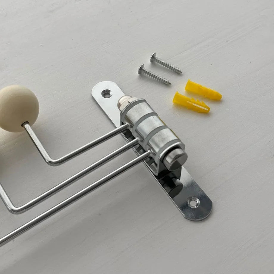 Detail of the cream swivel hook's mounting hardware, including screws and wall anchors - RoomDen.