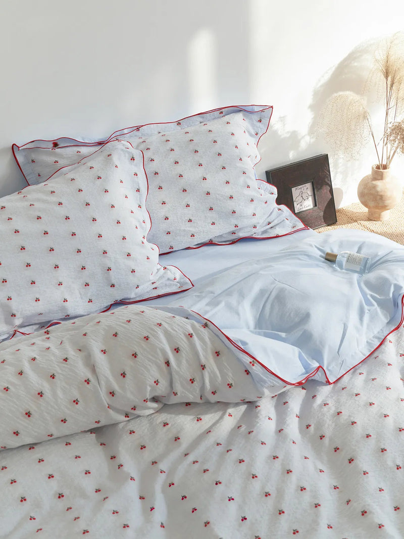Ruffled Cherry Print Washed Cotton Bedding Set on a bed in soft natural light — RoomDen
