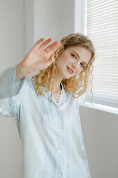 Close up of model waving in Silky Blue Pajama Set - RoomDen