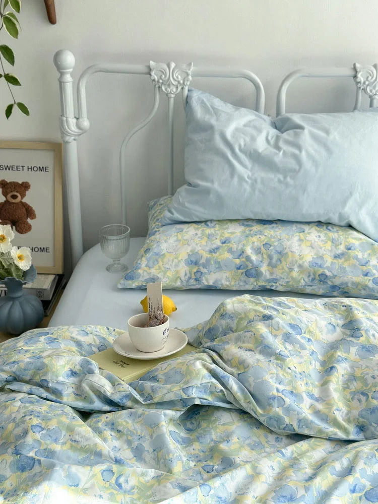 Detailed shot of the soft, crinkled texture of the floral duvet cover and a solid blue pillowcase.