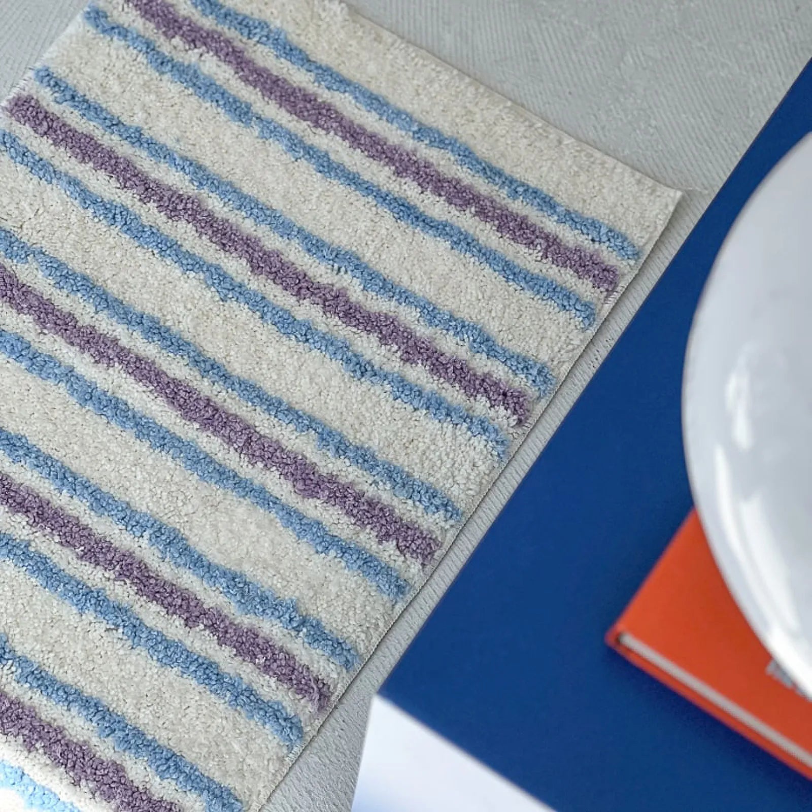 Detail View of Rug Edge and Wavy Pattern - RoomDen