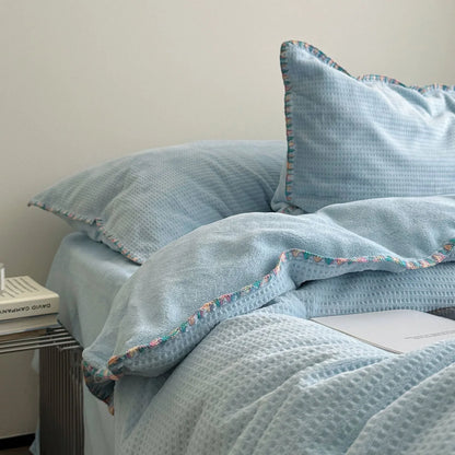Detail shot of the colorful crochet trim and soft texture on the Sky Blue duvet cover.