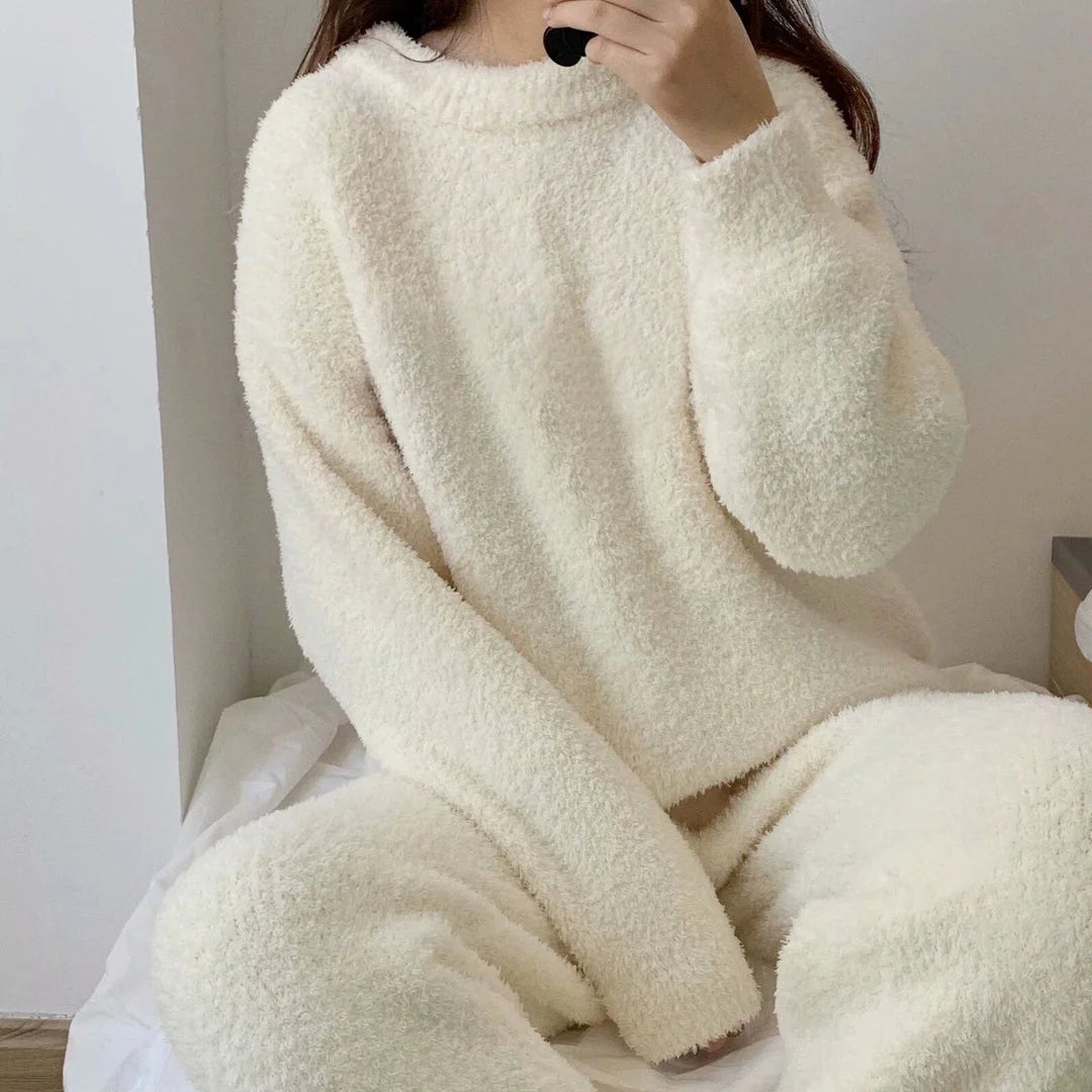 A relaxed view of the Cream White fuzzy fleece pajama set being worn in a bright room - RoomDen