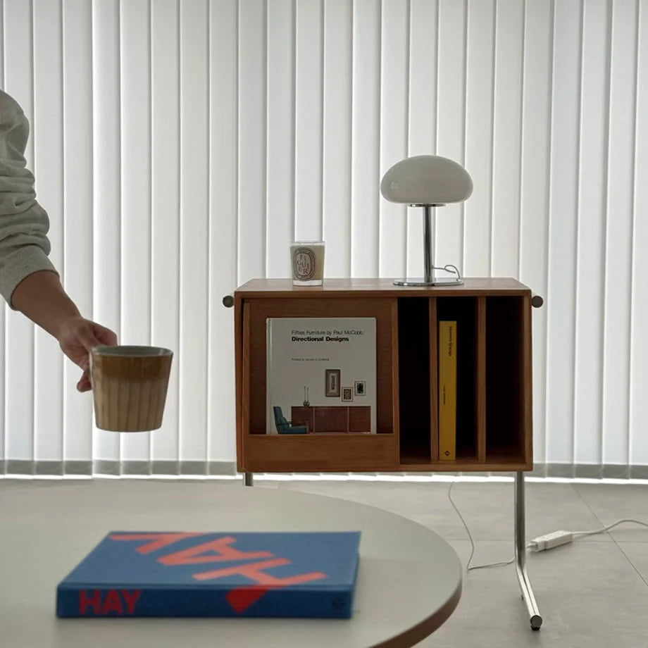 The white mushroom accent lamp (unlit) on a wooden side table in a bright room - RoomDen.