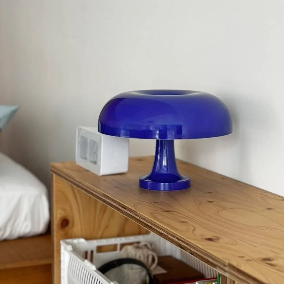 Angled view of the cobalt blue mushroom lamp on a wooden surface, showing its glossy finish - RoomDen.