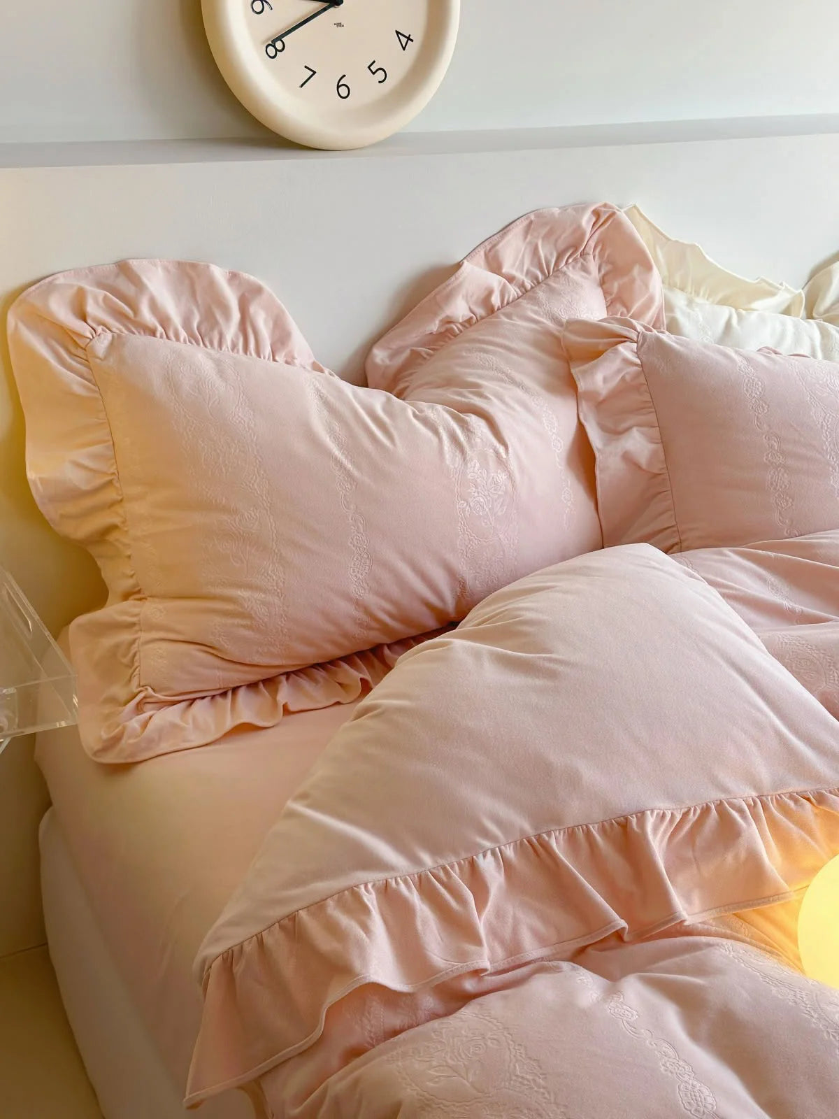 Close-up of the layered ruffled pillows of the Blush Pink velvet bedding set. - RoomDen