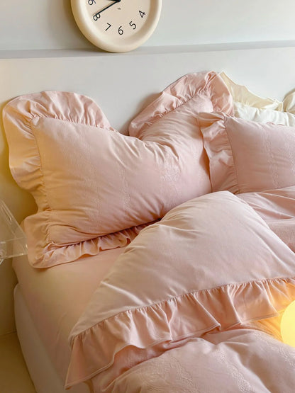 Close-up of the layered ruffled pillows of the Blush Pink velvet bedding set. - RoomDen