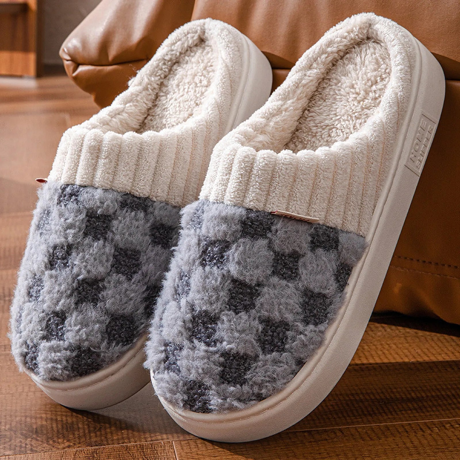 Close up of grey and white checkered plush house slippers - RoomDen
